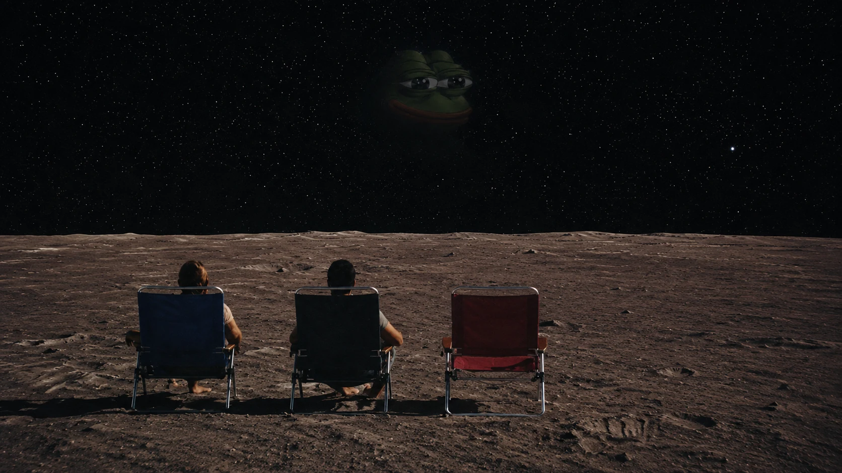 Two people sit in lunar folding chairs beside one empty chair facing Pepe